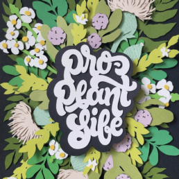 endangered flower and leaf paper cut illustration with hand-lettered phrase pro plant life