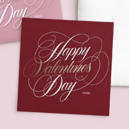 feminine, script, hand-lettering on stationery card that says happy valentines day