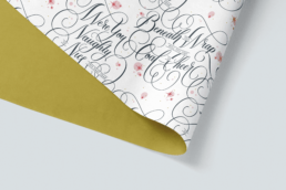 script, hand-lettering with flourishes for Christmas wrap paper that says were you naughty or nice this past year, beneath this wrap will you find coal or cheer